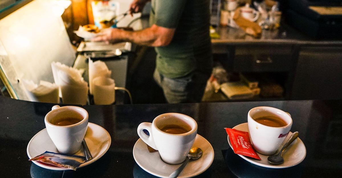 Barista preparing espresso at a Roman coffee bar