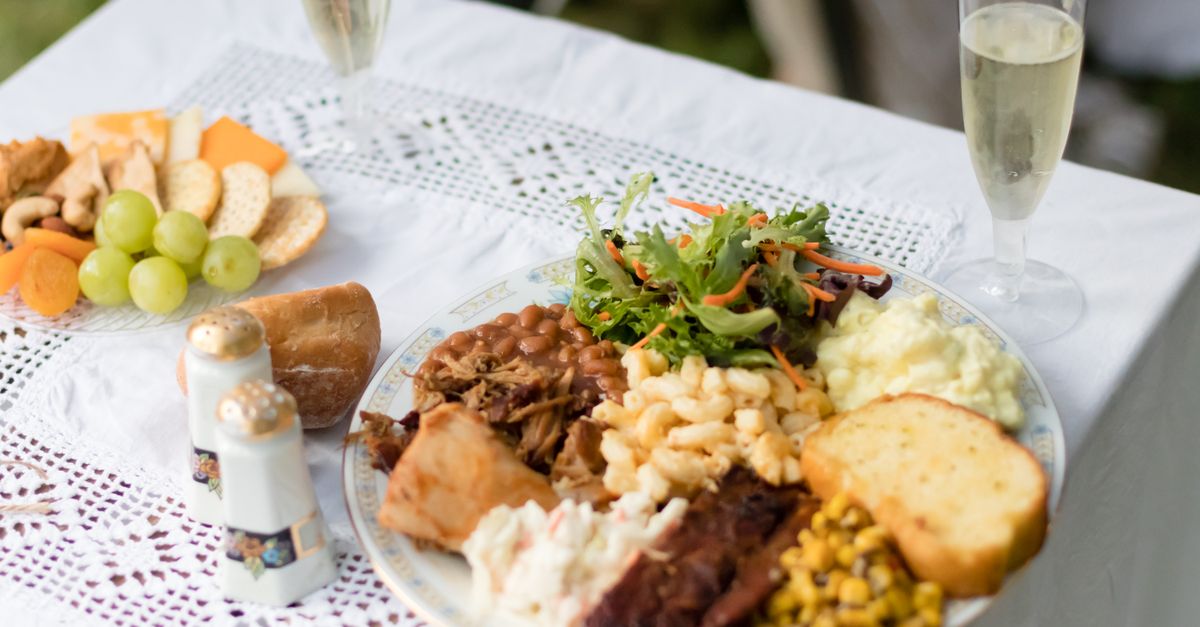 A plate of Hawaiian-style food including pulled pork, macaroni salad, and sides.