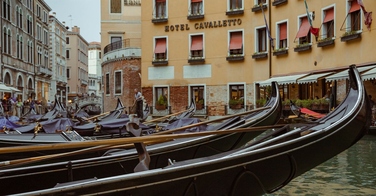 Gondolas docked in front of Hotel Cavalletto in Venice, Italy